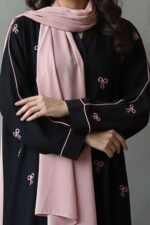 Black abaya with pink bow embroidery in crepe fabric by Nimah Wear